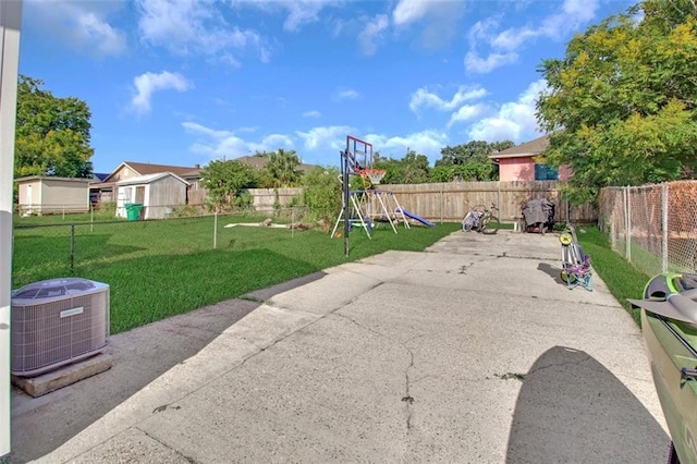 exterior space with central air condition unit, a fenced backyard, and a playground