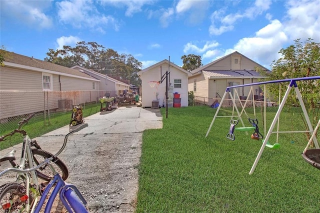 view of jungle gym featuring a fenced backyard, a yard, central AC, and a patio