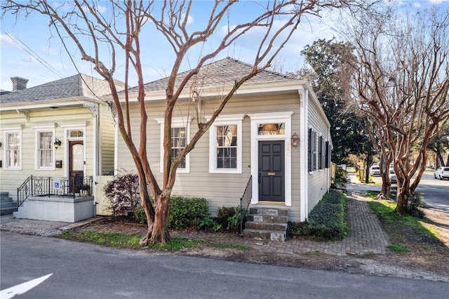 view of front of property with roof with shingles and entry steps