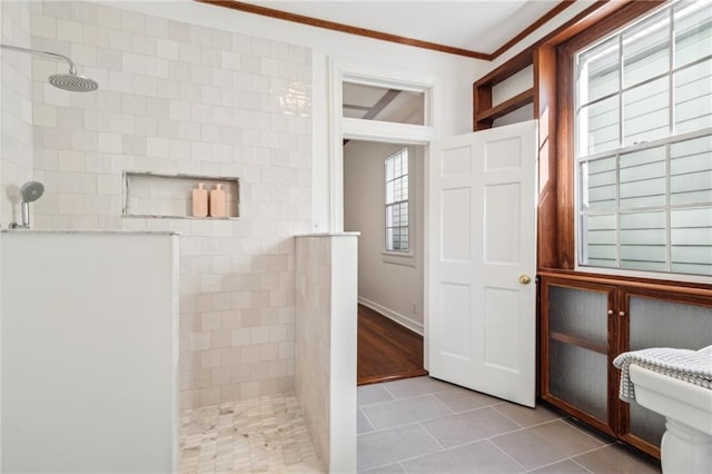 full bath with tile patterned floors, a walk in shower, and ornamental molding