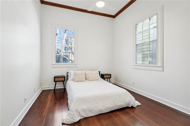 bedroom with ceiling fan, baseboards, ornamental molding, and dark wood-style flooring