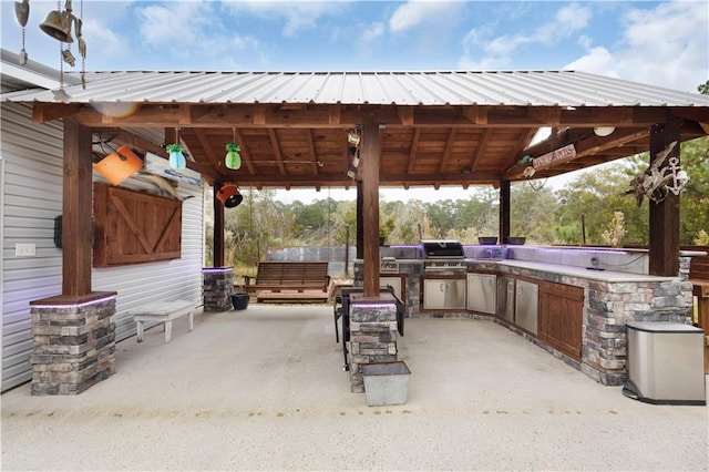 view of patio / terrace with a gazebo, area for grilling, and exterior kitchen