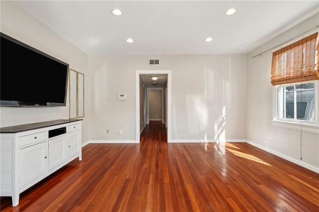 unfurnished living room with visible vents, recessed lighting, baseboards, and dark wood-style flooring