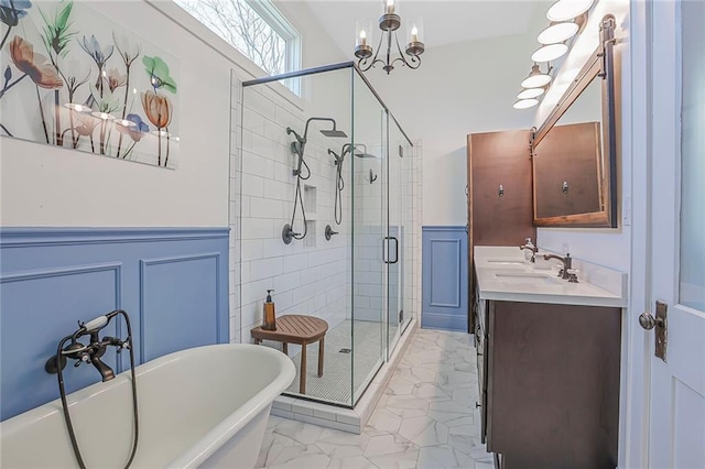 full bathroom with a freestanding bath, a shower stall, marble finish floor, and wainscoting