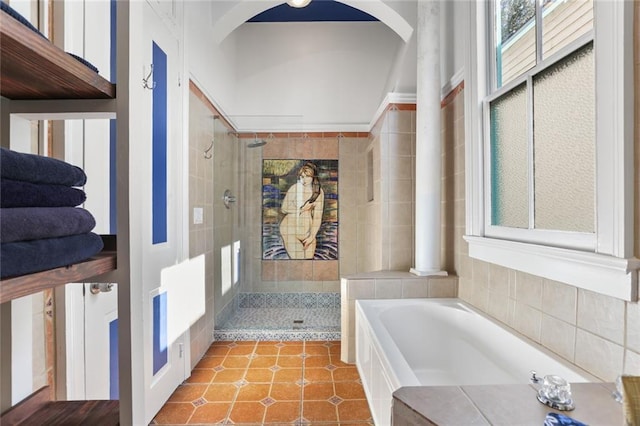 full bathroom featuring a bath, tile patterned floors, and a stall shower