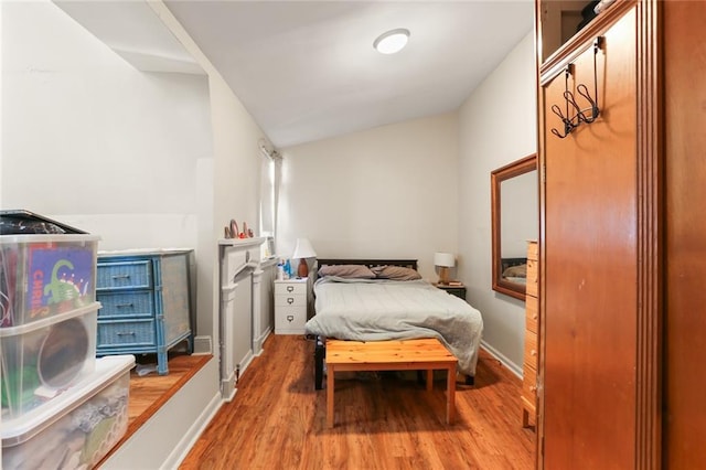 bedroom featuring light wood-type flooring and baseboards