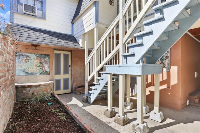 entrance to property with roof with shingles