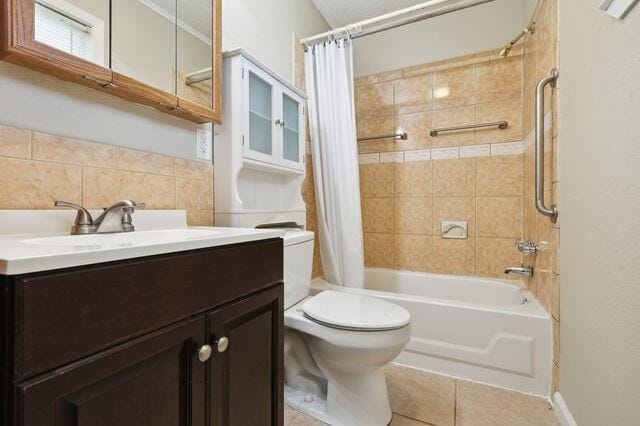 full bathroom with tile patterned flooring, shower / bath combination with curtain, toilet, and vanity