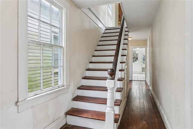 staircase featuring hardwood / wood-style flooring and baseboards