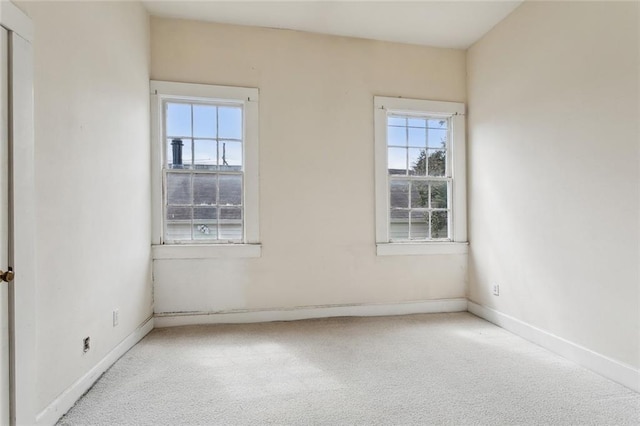 carpeted spare room with baseboards