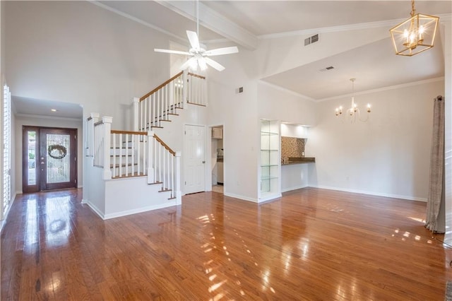 unfurnished living room with stairs, crown molding, baseboards, and wood-type flooring