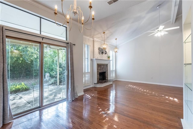 unfurnished living room featuring wood finished floors, visible vents, baseboards, a fireplace with raised hearth, and ceiling fan with notable chandelier