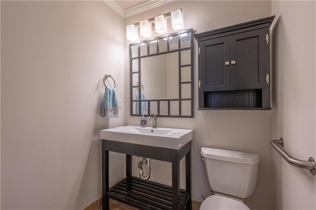 bathroom featuring crown molding and toilet