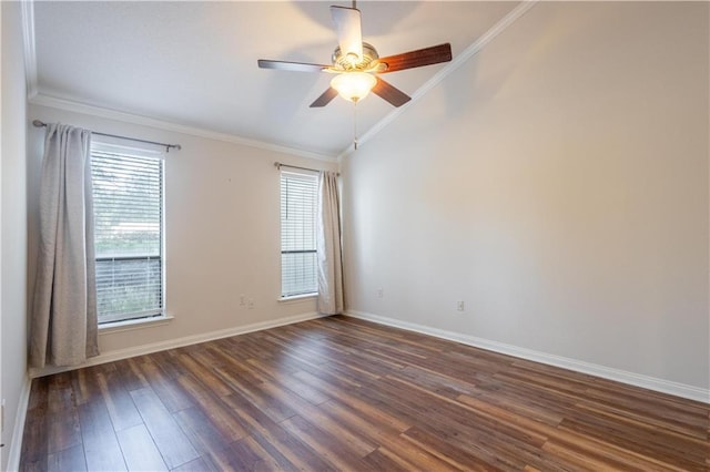 spare room featuring lofted ceiling, ornamental molding, a ceiling fan, dark wood finished floors, and baseboards