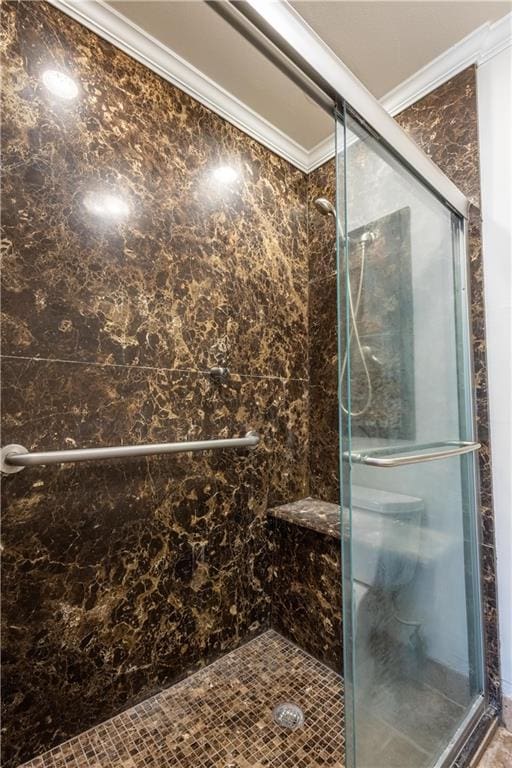 bathroom featuring a shower stall and crown molding