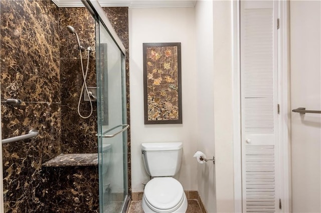 bathroom featuring a shower stall, toilet, and a closet