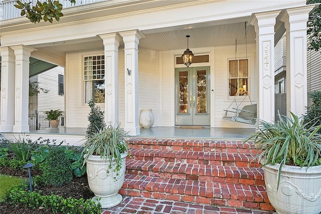 doorway to property featuring french doors and a porch