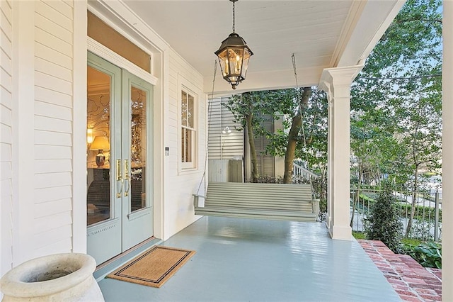 view of patio featuring a porch and french doors