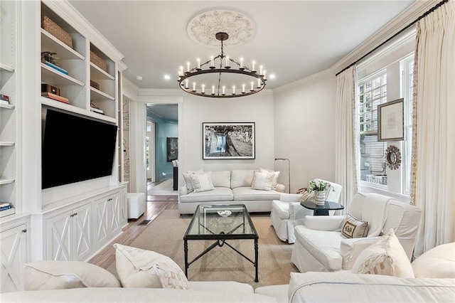 living area featuring a notable chandelier, crown molding, light wood-style floors, and built in features