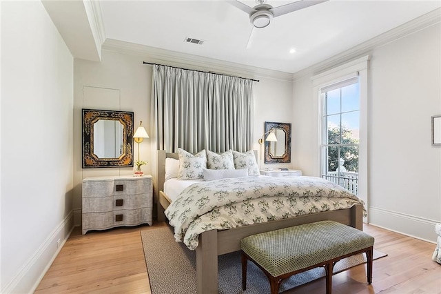 bedroom with crown molding, light wood-style floors, visible vents, and baseboards