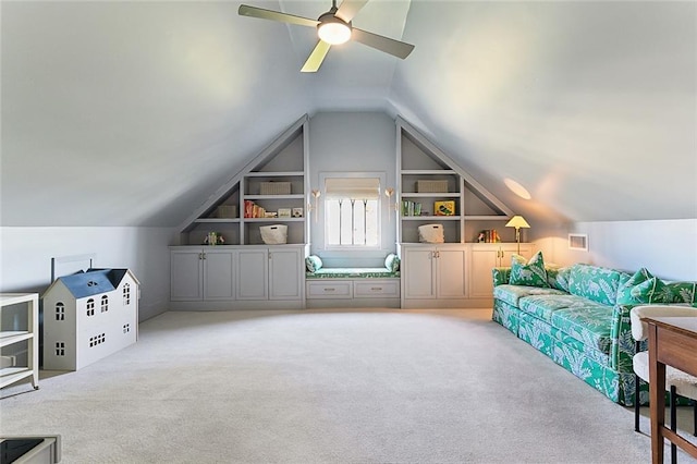 additional living space with visible vents, carpet, built in features, lofted ceiling, and a ceiling fan