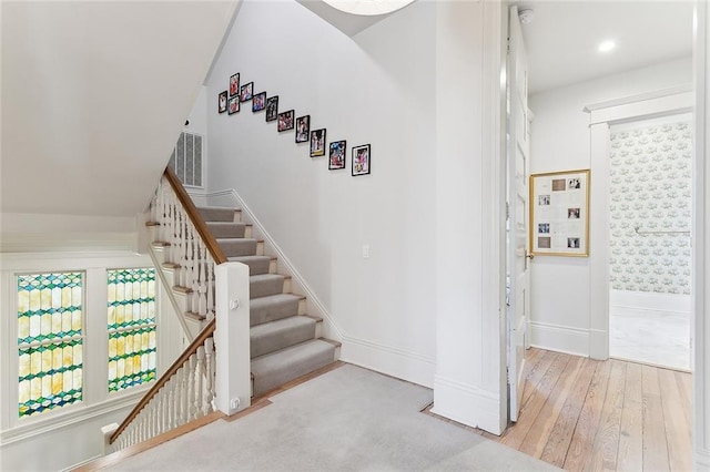 stairs featuring baseboards and hardwood / wood-style floors