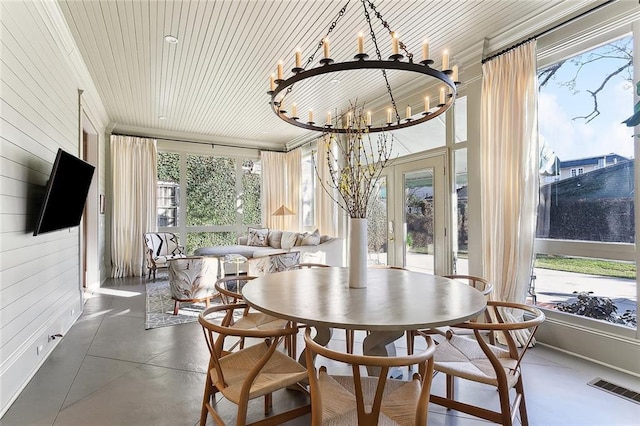 sunroom / solarium with a wealth of natural light, visible vents, wood ceiling, and a chandelier