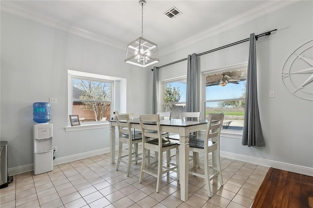 dining space featuring visible vents, a wealth of natural light, and ornamental molding