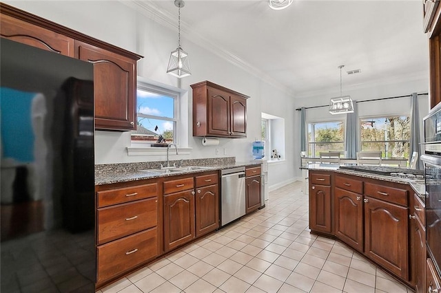 kitchen featuring visible vents, ornamental molding, appliances with stainless steel finishes, and a sink