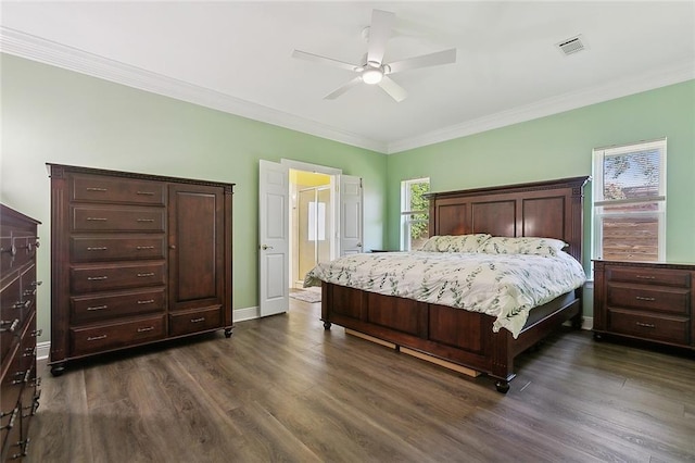 bedroom with visible vents, crown molding, baseboards, dark wood-style floors, and a ceiling fan