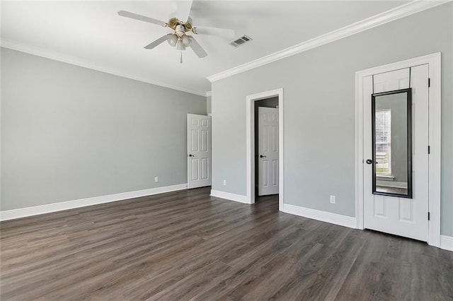 unfurnished bedroom with visible vents, dark wood-type flooring, ornamental molding, baseboards, and ceiling fan