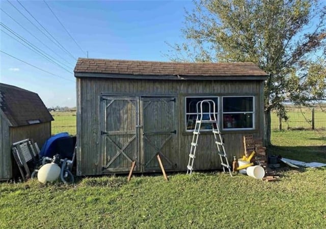 view of shed with fence