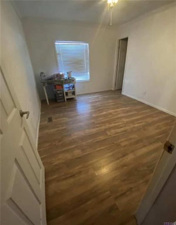 spare room featuring wood finished floors