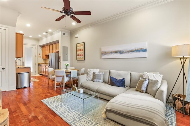 living room with a ceiling fan, wood finished floors, baseboards, recessed lighting, and crown molding