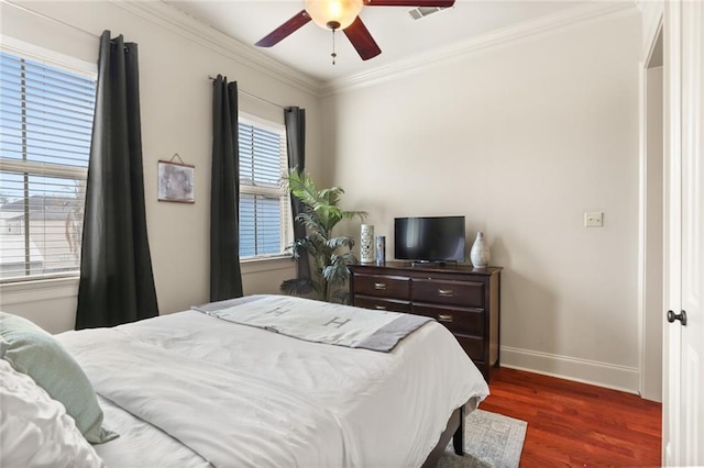 bedroom with dark wood finished floors, crown molding, a ceiling fan, and baseboards