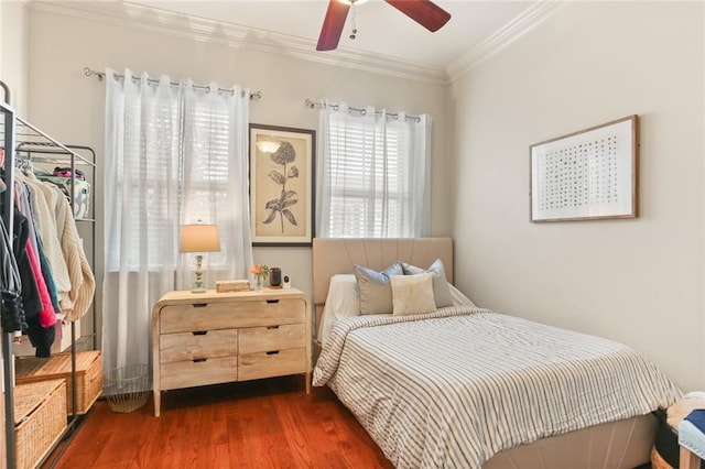 bedroom with ceiling fan, dark wood-style flooring, and crown molding