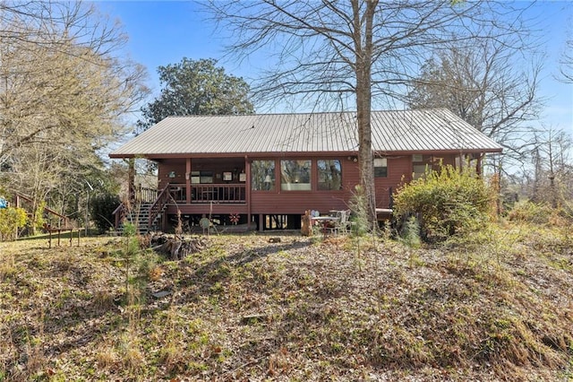 rear view of property featuring metal roof