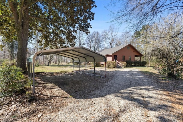 view of parking / parking lot with a detached carport and driveway