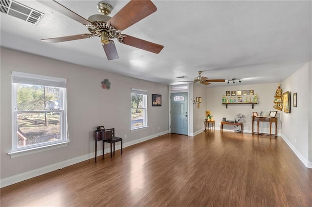 interior space featuring visible vents, baseboards, and wood finished floors