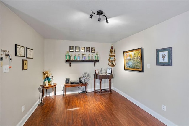 interior space with baseboards and wood finished floors