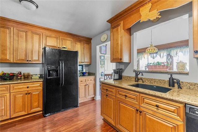 kitchen featuring a sink, brown cabinets, black appliances, and dark wood finished floors