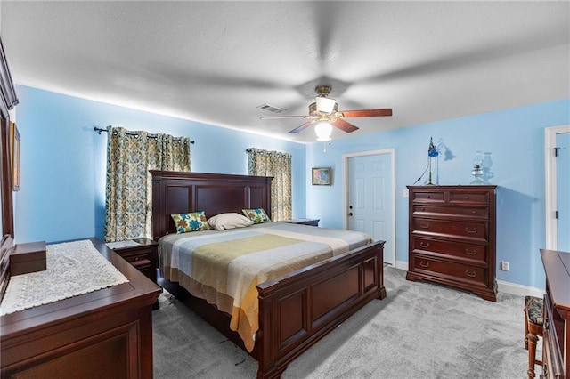 bedroom with visible vents, light colored carpet, a ceiling fan, and baseboards