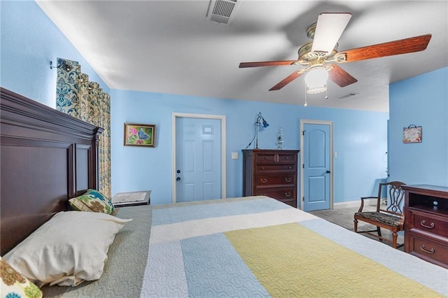 carpeted bedroom featuring visible vents, baseboards, and a ceiling fan