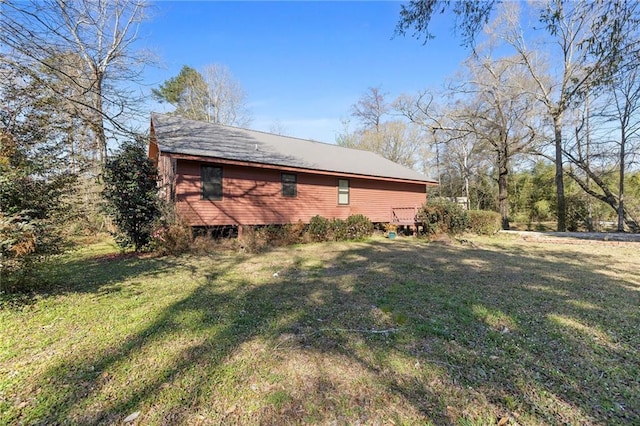 view of side of home with a lawn