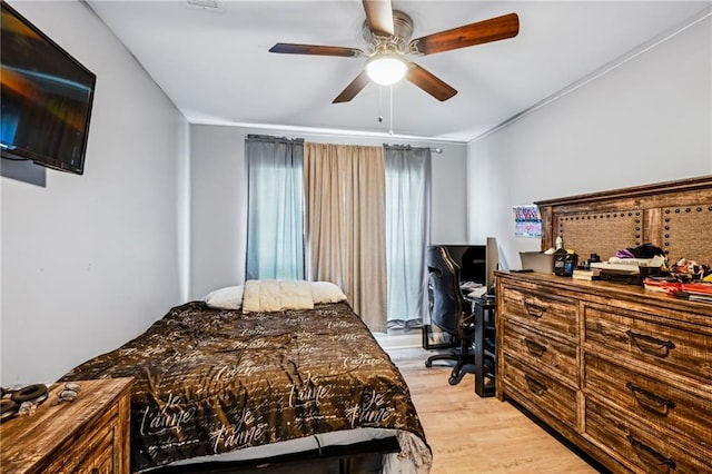 bedroom with light wood-style floors and a ceiling fan