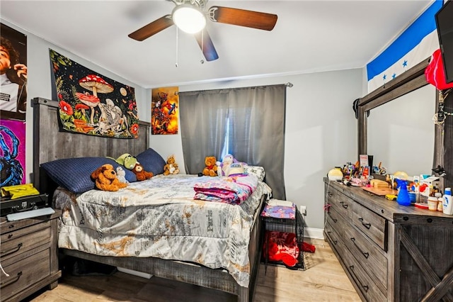 bedroom with wood finished floors and a ceiling fan