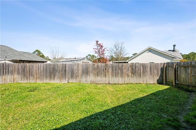 view of yard with a fenced backyard