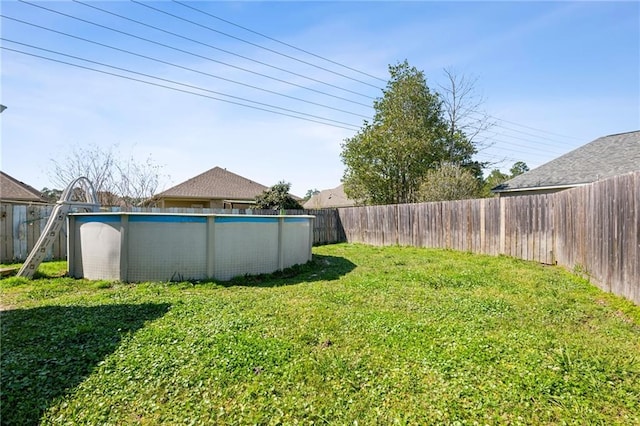 view of yard with a fenced in pool and a fenced backyard