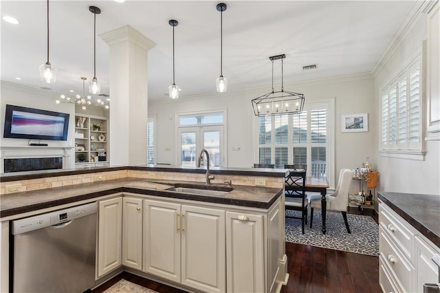 kitchen with a sink, visible vents, dishwasher, and ornamental molding