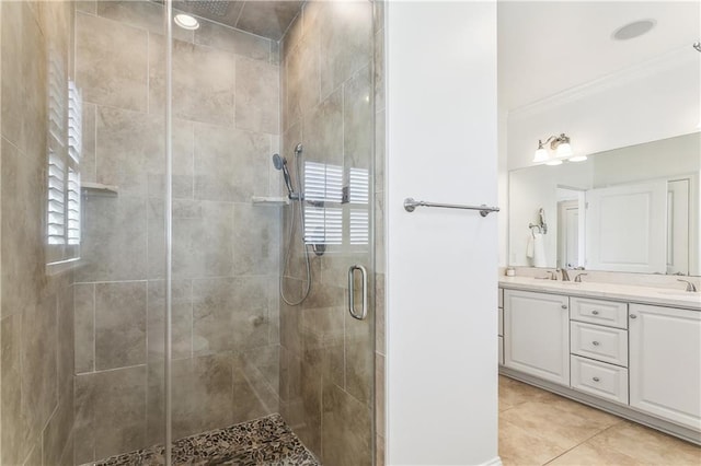 full bath featuring tile patterned flooring, a shower stall, double vanity, and a sink